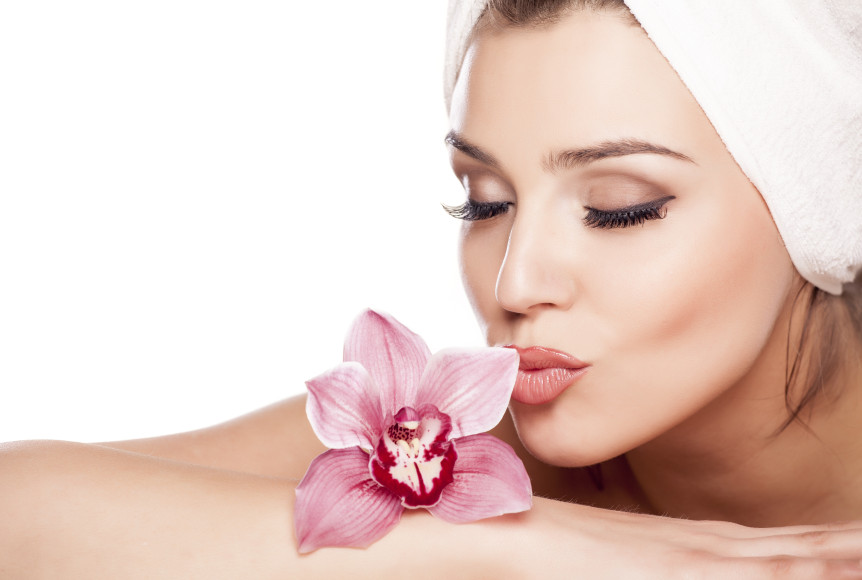 beautiful woman with a towel on her head and kissing orchid